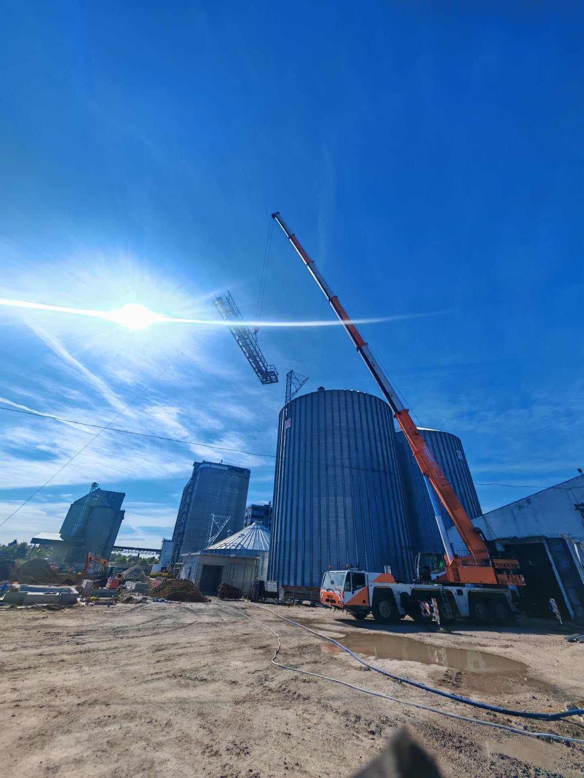 Grain silo complex with industrial conveyors at golden hour